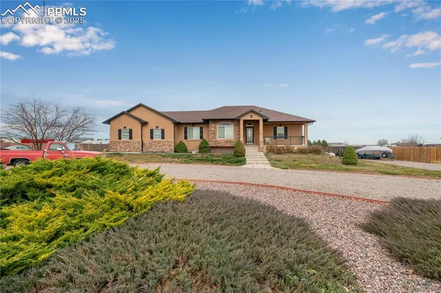 a living room with furniture a flat screen tv and a table