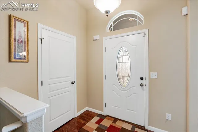 a front view of house with yard and trees around