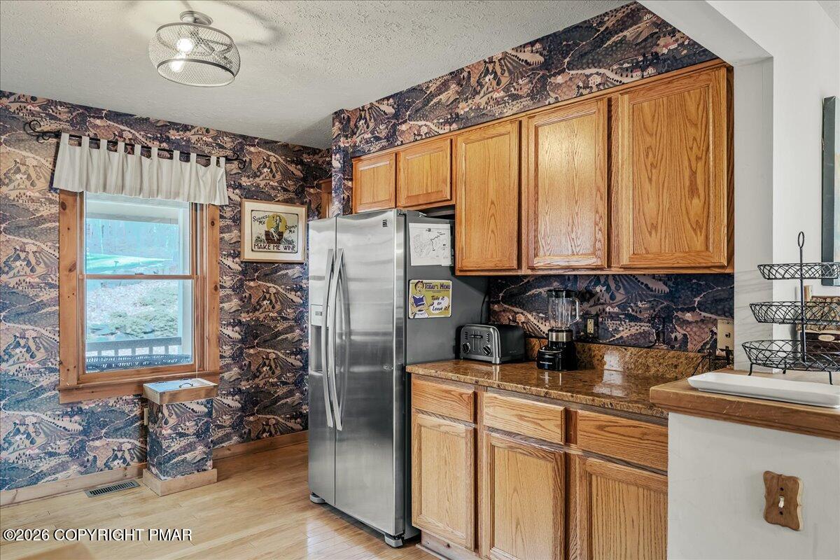 723 Lower Deer Valley Road Tannersville, PA 18372 - Photo 13 of 58 a kitchen with stainless steel appliances granite countertop a refrigerator and a sink