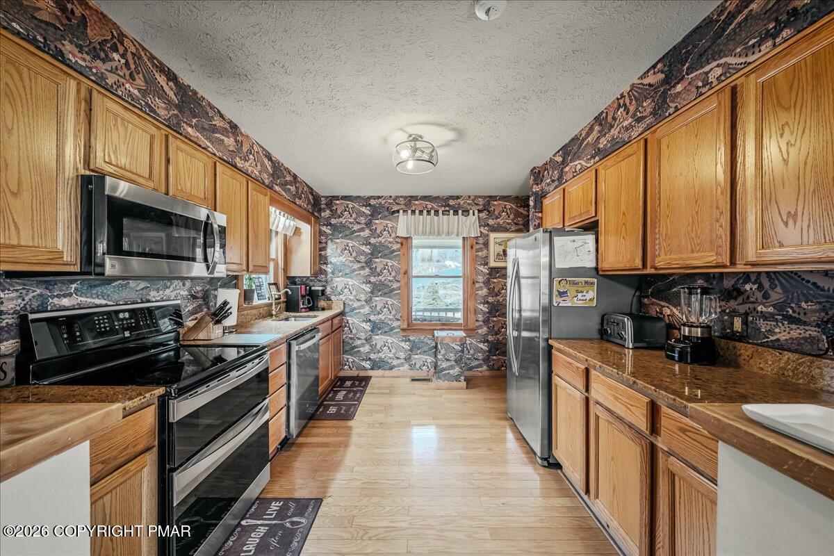 723 Lower Deer Valley Road Tannersville, PA 18372 - Photo 14 of 58 a kitchen with stainless steel appliances a stove sink microwave and cabinets