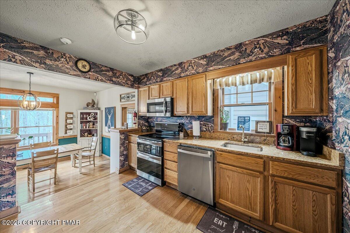 723 Lower Deer Valley Road Tannersville, PA 18372 - Photo 16 of 58 a kitchen with stainless steel appliances granite countertop a stove a sink dishwasher and a microwave oven with cabinets