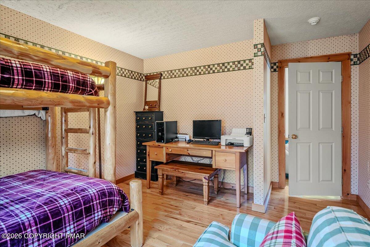 723 Lower Deer Valley Road Tannersville, PA 18372 - Photo 19 of 58 a bedroom with a bed and a desk