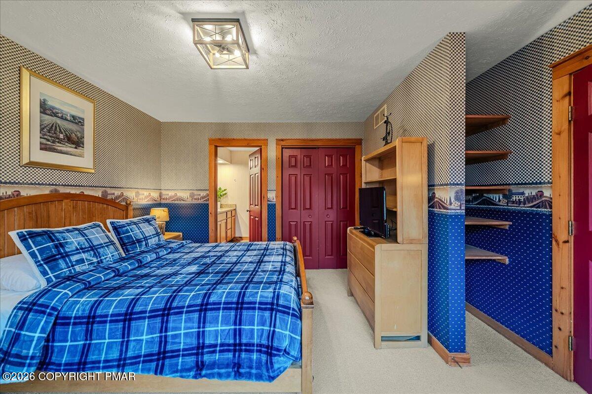 723 Lower Deer Valley Road Tannersville, PA 18372 - Photo 24 of 58 a bedroom with a bed and a flat tv screen on dresser