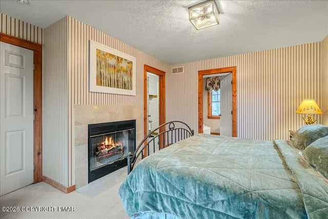 a bedroom with a bed and a fireplace