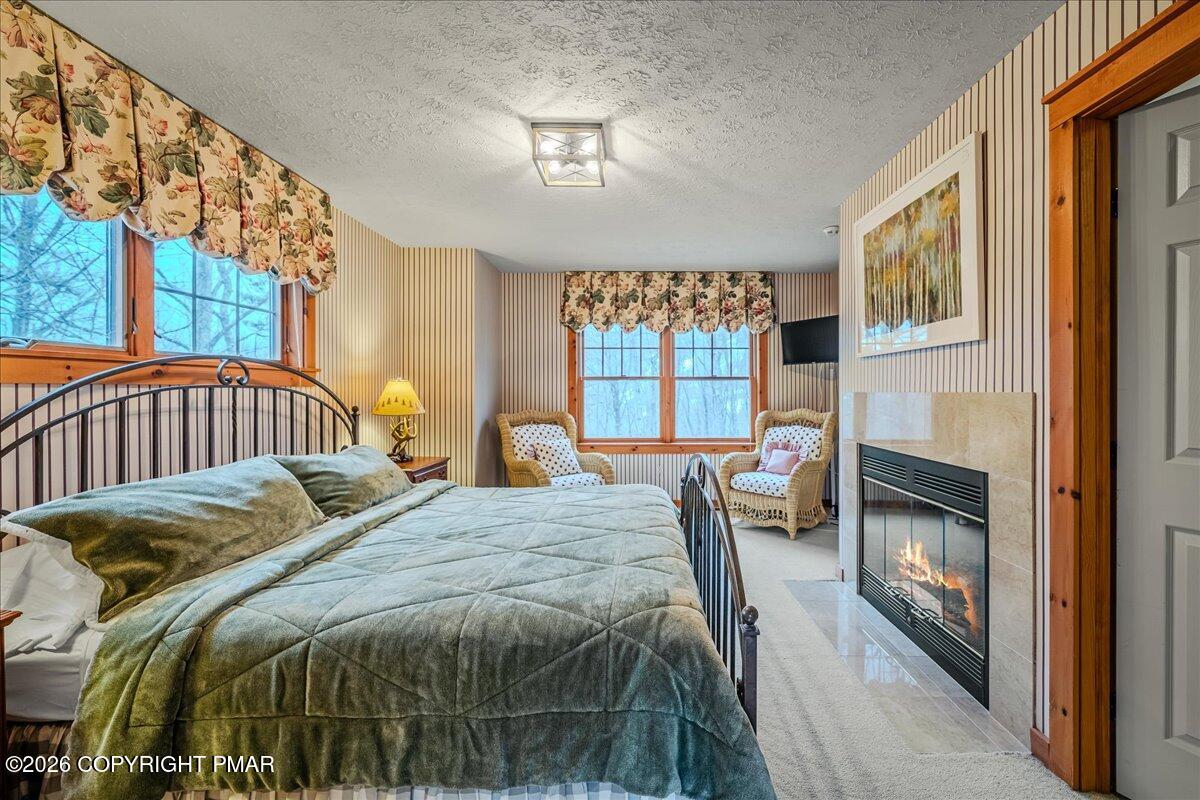 723 Lower Deer Valley Road Tannersville, PA 18372 - Photo 29 of 58 a bedroom with a bed and a fireplace
