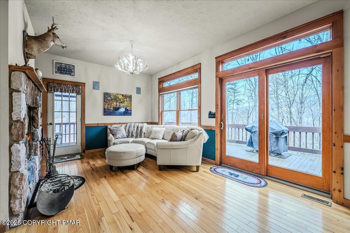 723 Lower Deer Valley Road Tannersville, PA 18372 - Photo 8 of 58 a living room with furniture and a floor to ceiling window