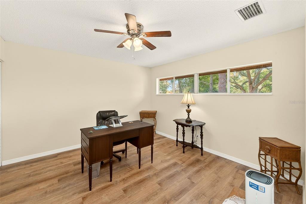 2064 Sunset Point Road, Unit 73 Clearwater, FL 33765 - Photo 33 of 58 a view of a workspace with furniture and wooden floor