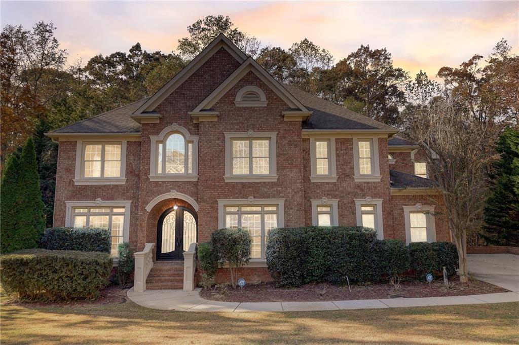a front view of a house with garden