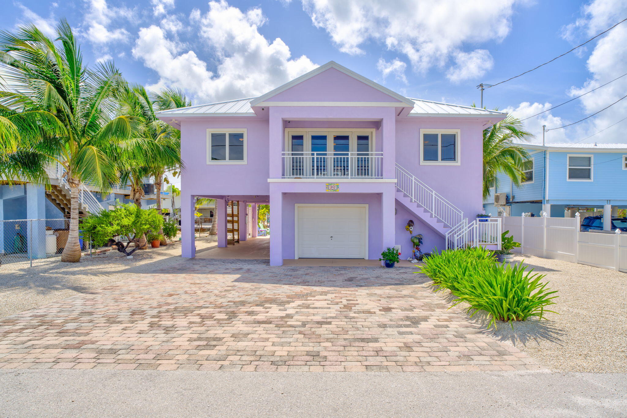 823 Indies Road Summerland Key, FL 33042 - Photo 2 of 48 a front view of a house with a yard and garage