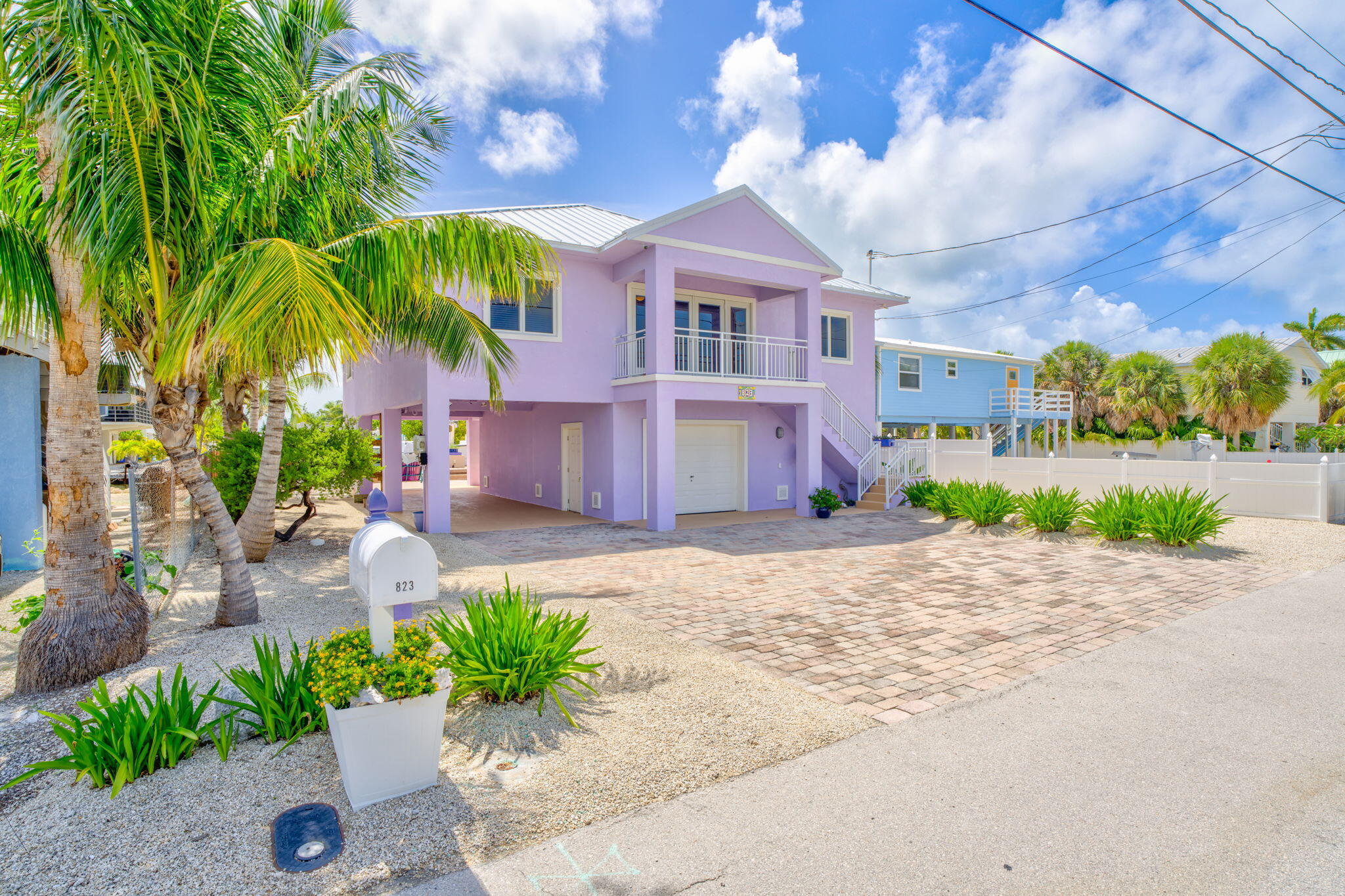 823 Indies Road Summerland Key, FL 33042 - Photo 40 of 48 a front view of a house with a yard and a garage