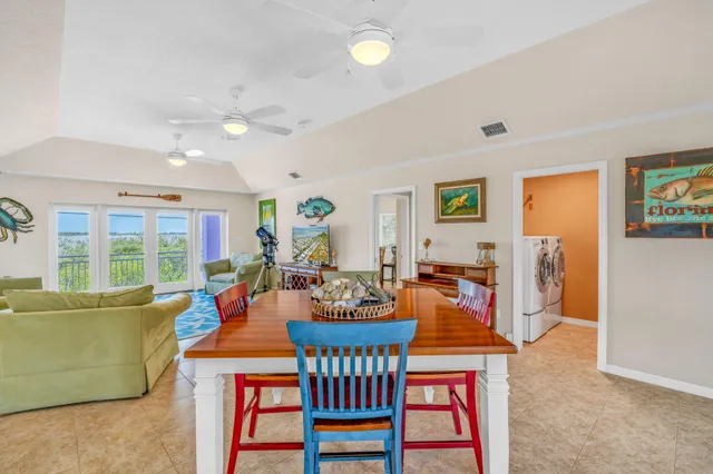 a view of a dining room with furniture a chandelier and wooden floor