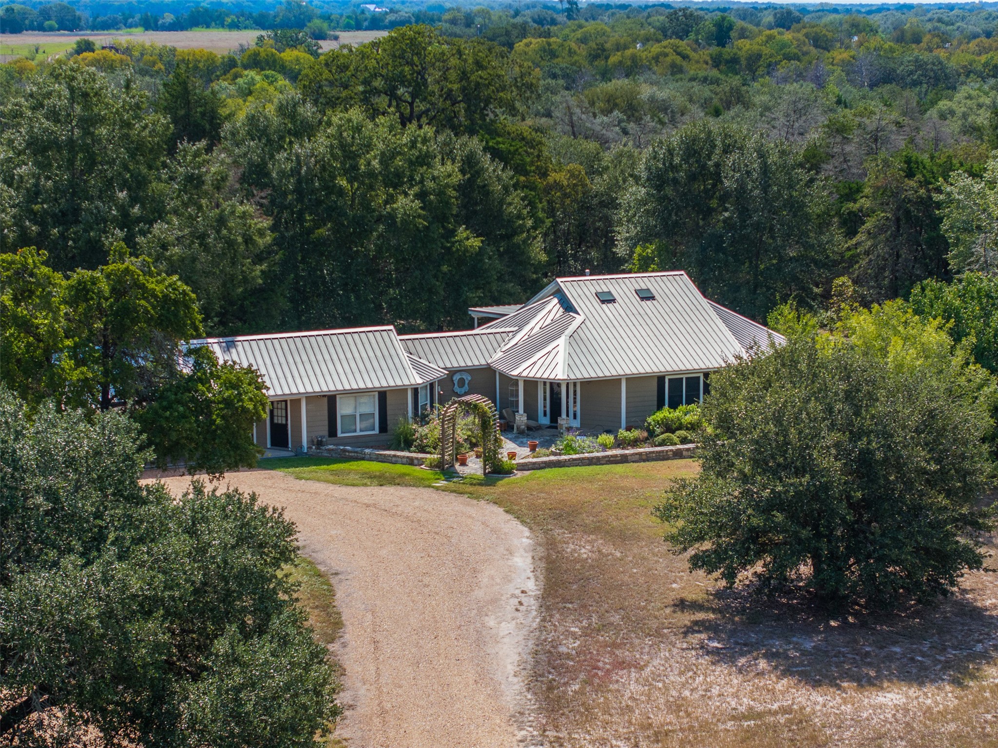an aerial view of a house with swimming pool and garden