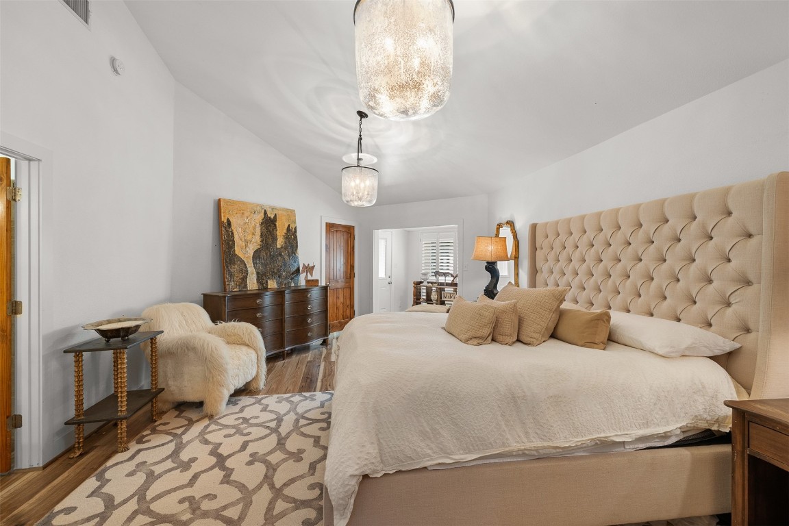 235 Floyd Lane Round Top, TX 78954 - Photo 11 of 19 a bedroom with a bed and wooden floor
