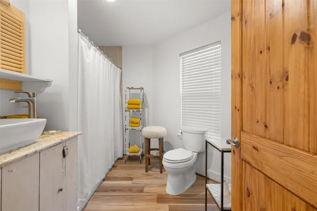 a white toilet sitting next to a bathroom sink