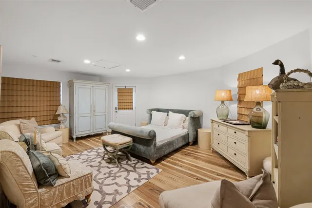 a spacious bedroom with a bed and a couch