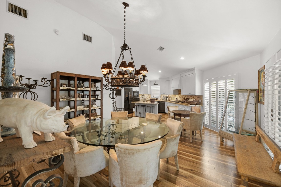 235 Floyd Lane Round Top, TX 78954 - Photo 2 of 19 a view of a dining room and livingroom with furniture wooden floor a chandelier