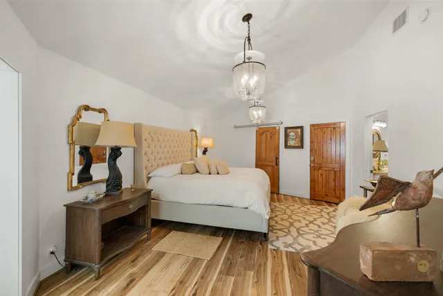 a bedroom with a bed and wooden floor