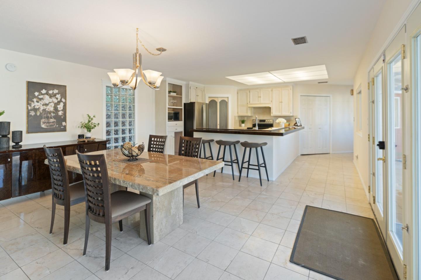 112 Alto Sol Court Scotts Valley, CA 95066 - Photo 12 of 58 a kitchen with kitchen island granite countertop a table chairs sink and cabinets