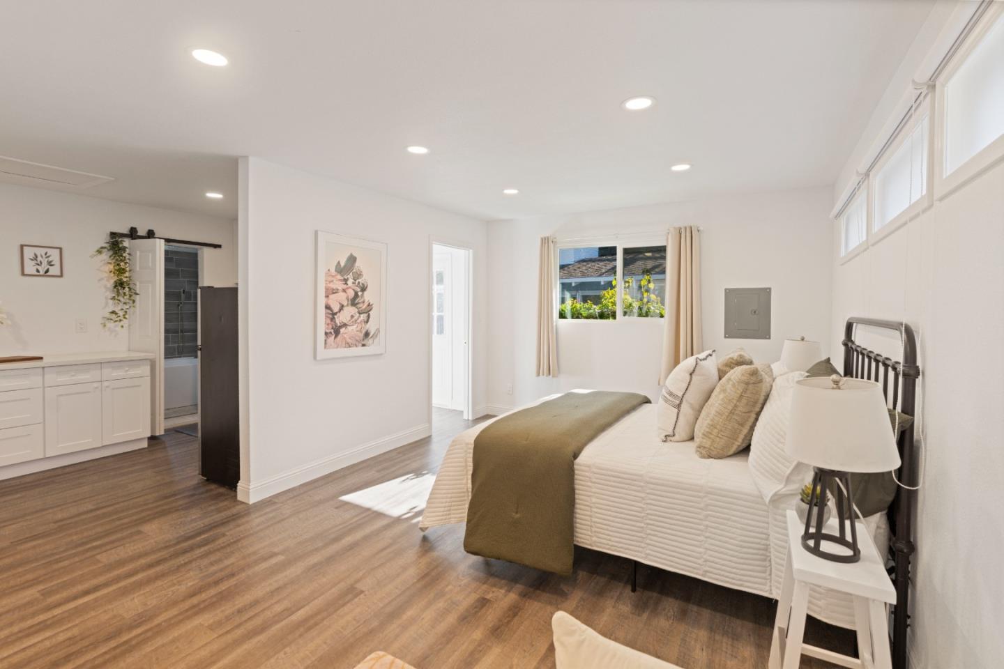 112 Alto Sol Court Scotts Valley, CA 95066 - Photo 30 of 58 a bedroom with a large bed and wooden floor