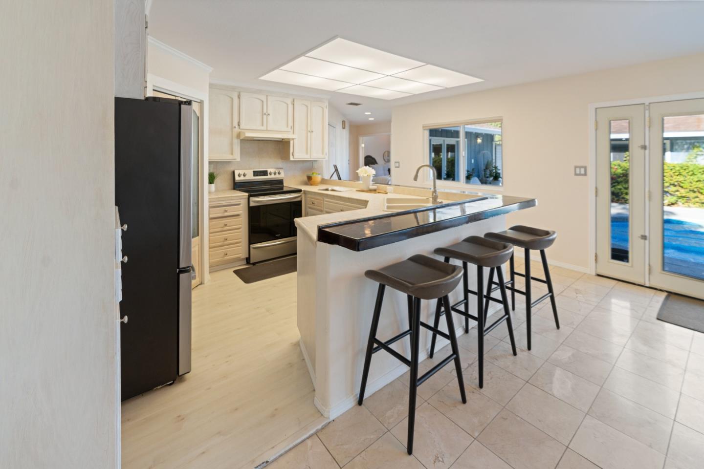 112 Alto Sol Court Scotts Valley, CA 95066 - Photo 10 of 58 a kitchen with stainless steel appliances kitchen island granite countertop a refrigerator and a stove top oven