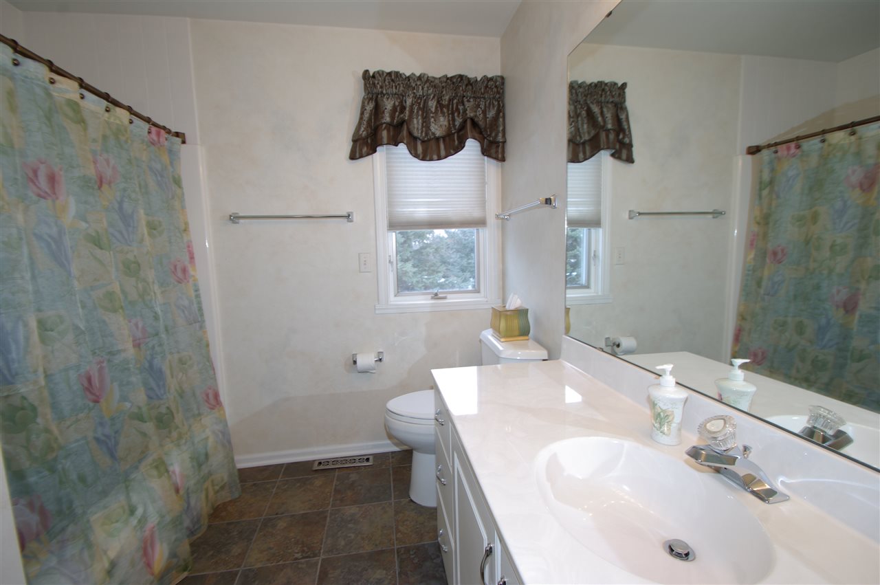 781 Timber Ridge Trail Rockford, IL 61114 - Photo 11 of 24 a bathroom with a sink and a mirror