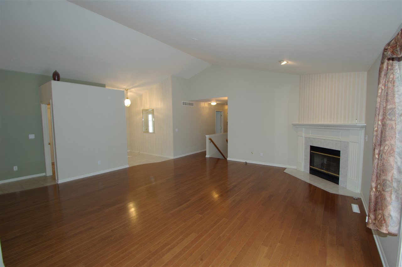 781 Timber Ridge Trail Rockford, IL 61114 - Photo 2 of 24 a view of empty room with wooden floor and fireplace