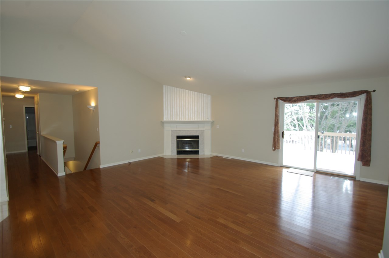 781 Timber Ridge Trail Rockford, IL 61114 - Photo 3 of 24 a view of an empty room with wooden floor and a window