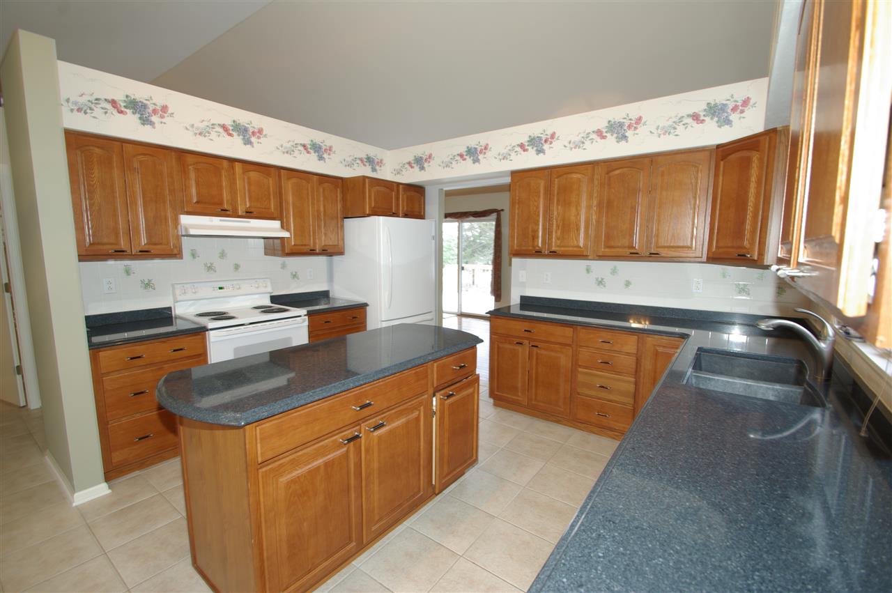781 Timber Ridge Trail Rockford, IL 61114 - Photo 5 of 24 a kitchen with stainless steel appliances granite countertop a sink stove and refrigerator