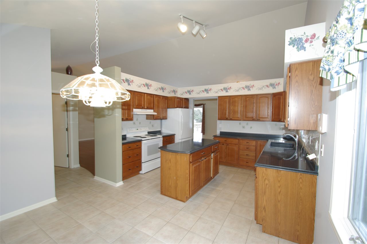 781 Timber Ridge Trail Rockford, IL 61114 - Photo 6 of 24 a living room with furniture and a chandelier