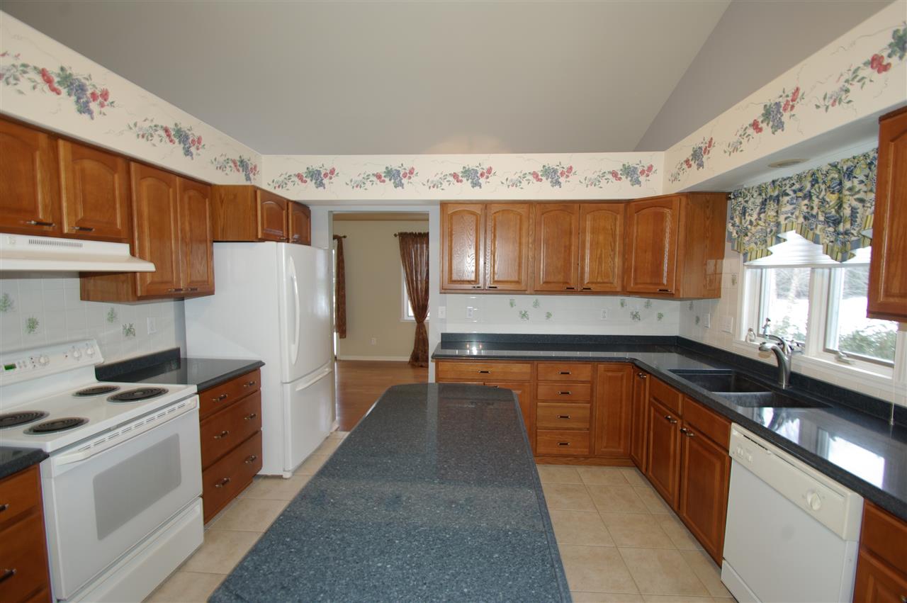 781 Timber Ridge Trail Rockford, IL 61114 - Photo 7 of 24 a kitchen with a sink a refrigerator and cabinets