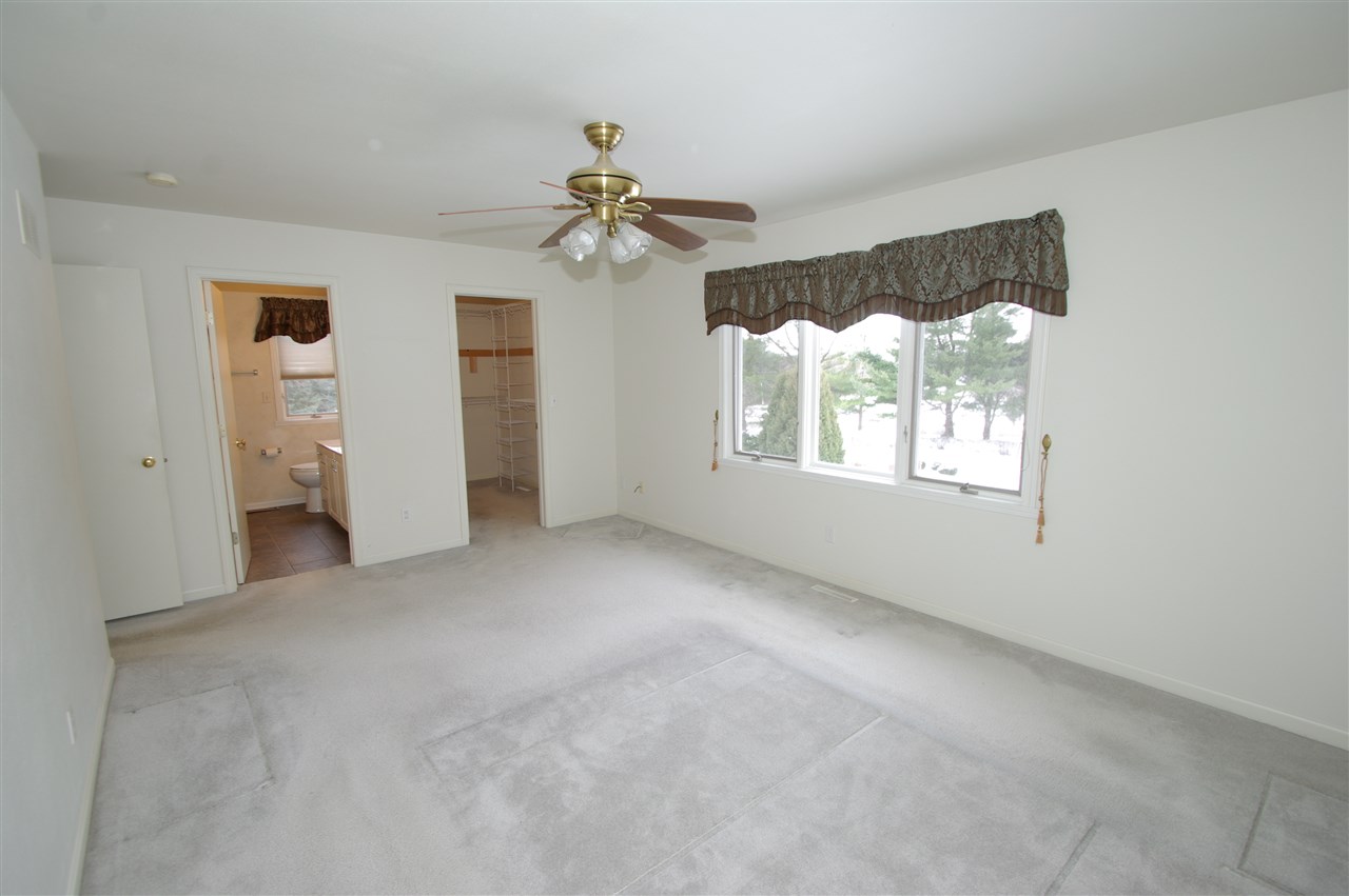 781 Timber Ridge Trail Rockford, IL 61114 - Photo 10 of 24 an empty room with windows and ceiling fan