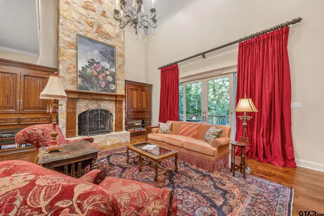 a living room with furniture a rug and a fireplace