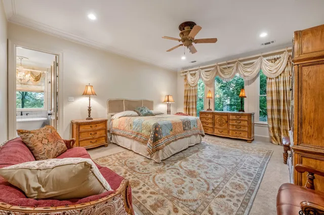 a bedroom with a bed and a large window