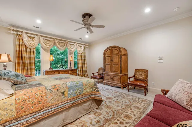 a bedroom with furniture and a large window