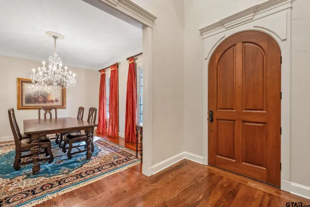 a view of a room with wooden floor wooden floor and chandelier
