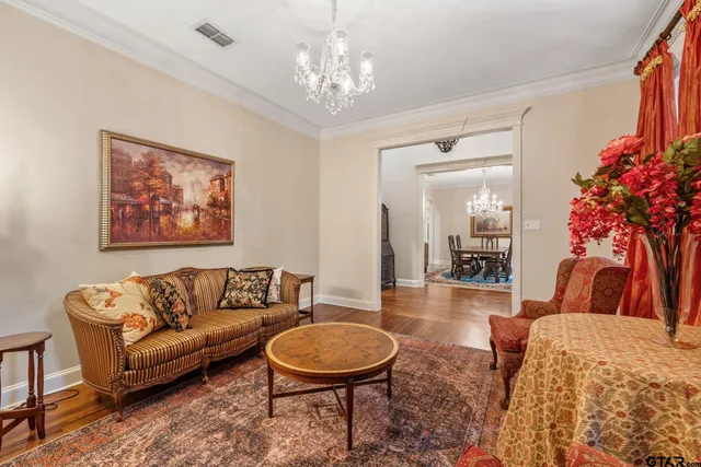 a living room with furniture a lamp and a chandelier
