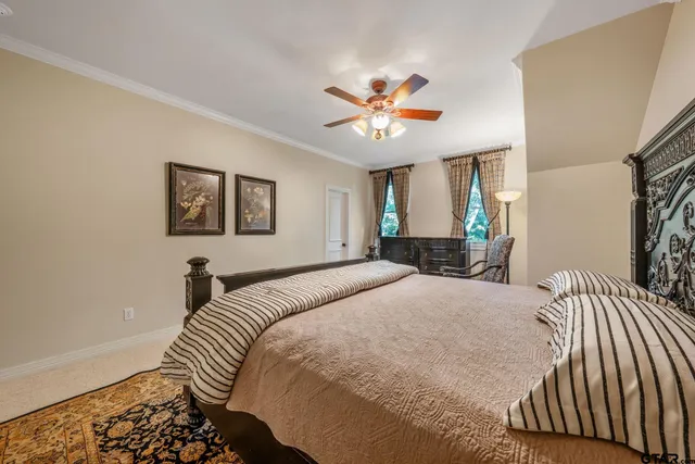 a bedroom with a bed and a chandelier