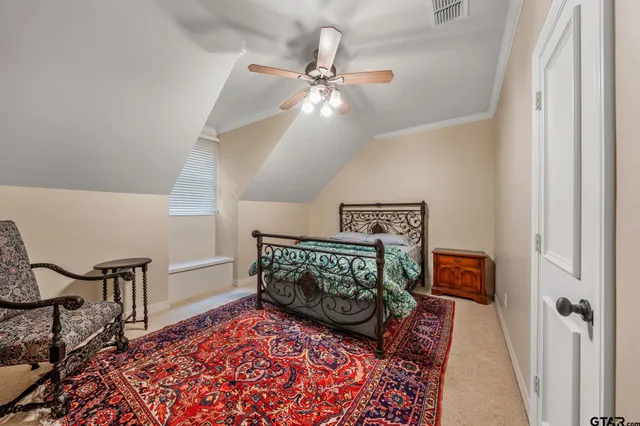 a bedroom with furniture and a rug