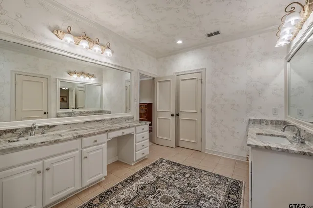 a spacious bathroom with a granite countertop sink mirror and a