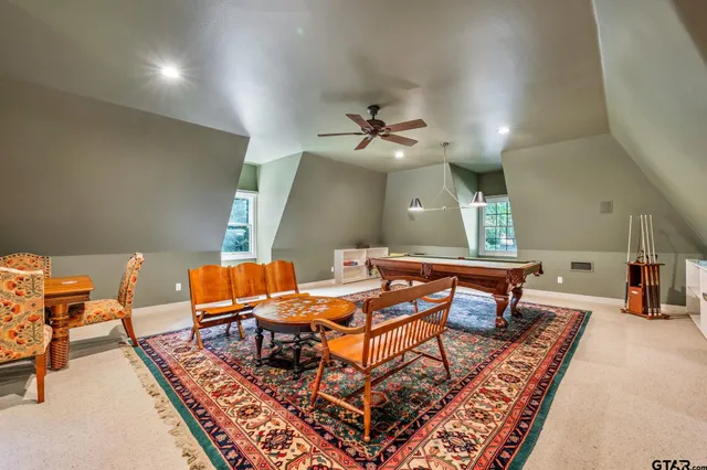 a living room with furniture a rug and a chandelier