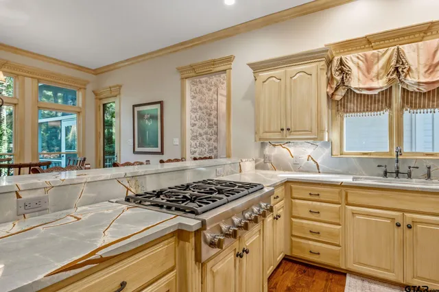 a kitchen with a stove a sink and a window