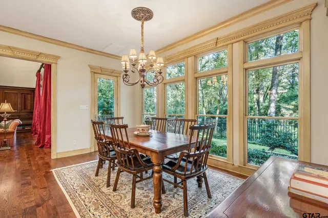a view of a dining room with furniture wooden floor and chandelier