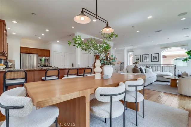 a large living room with kitchen island furniture and a chandelier