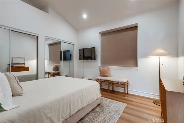 a bedroom with a bed and a night stand