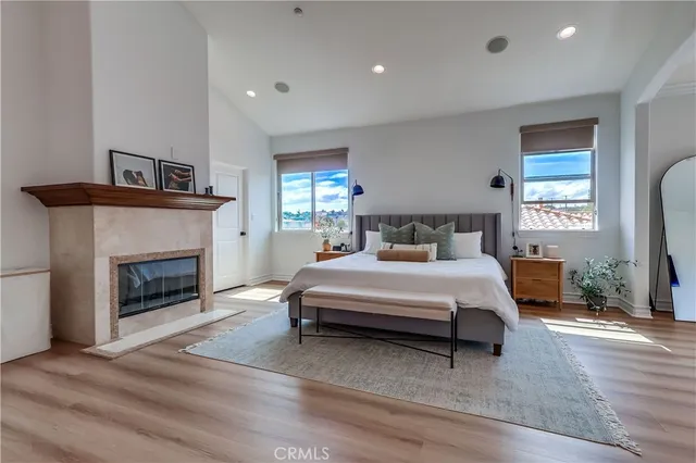 a bedroom with a large bed and a chandelier