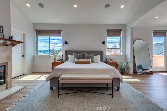 a spacious bedroom with a bed and a flat screen tv