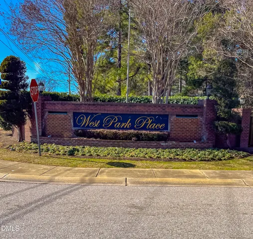 a view of swimming pool with a bench and trees