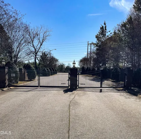 a view of a tennis court with a house in the background