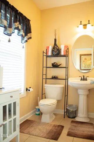 a bathroom with a sink toilet and a mirror