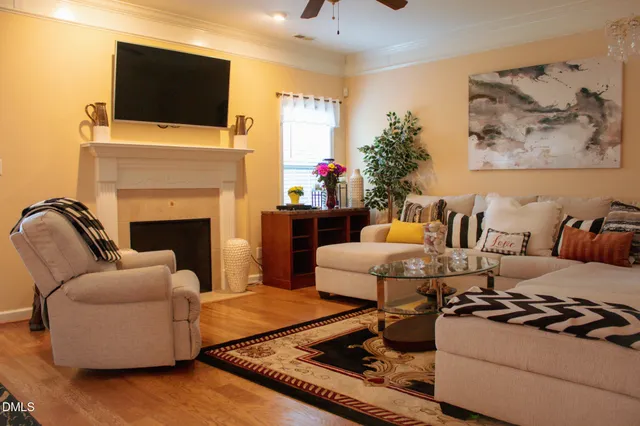 a living room with furniture fireplace and flat screen tv